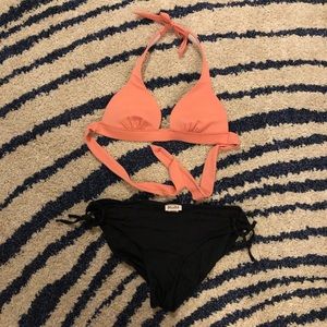 Coral bikini top and black bottoms